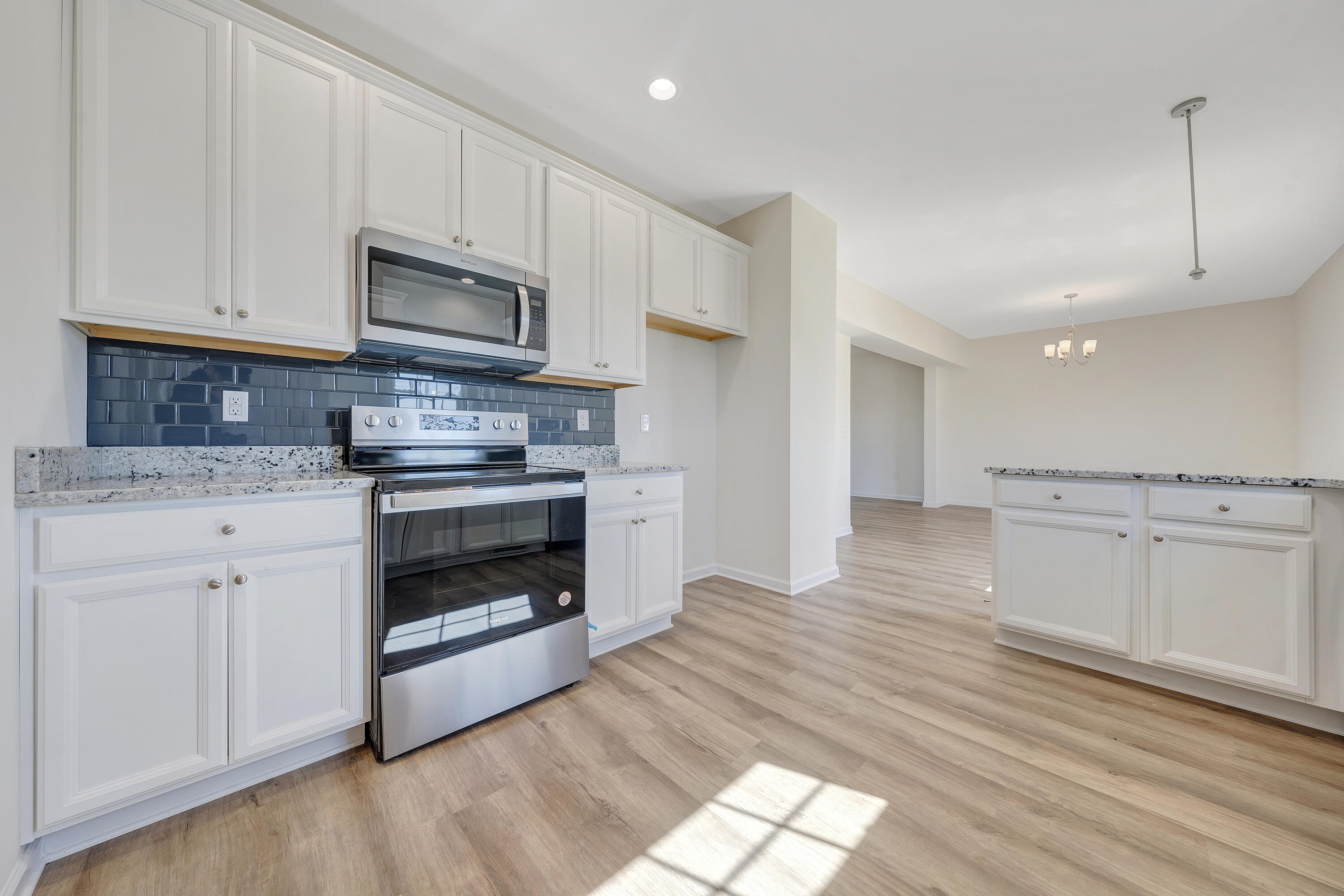 3076 Isabel Lane Salem, VA 24153 - Photo 8 of 16 a kitchen with stainless steel appliances white cabinets and a wooden floors