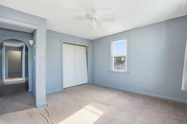 an empty room with windows and closet