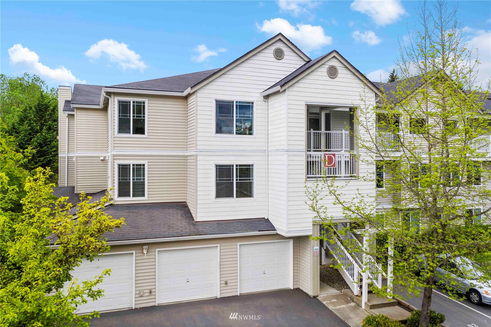 2009 196th Street Southeast, Unit D201 Bothell, WA 98012 - Photo 1 of 30 a front view of a house with a yard