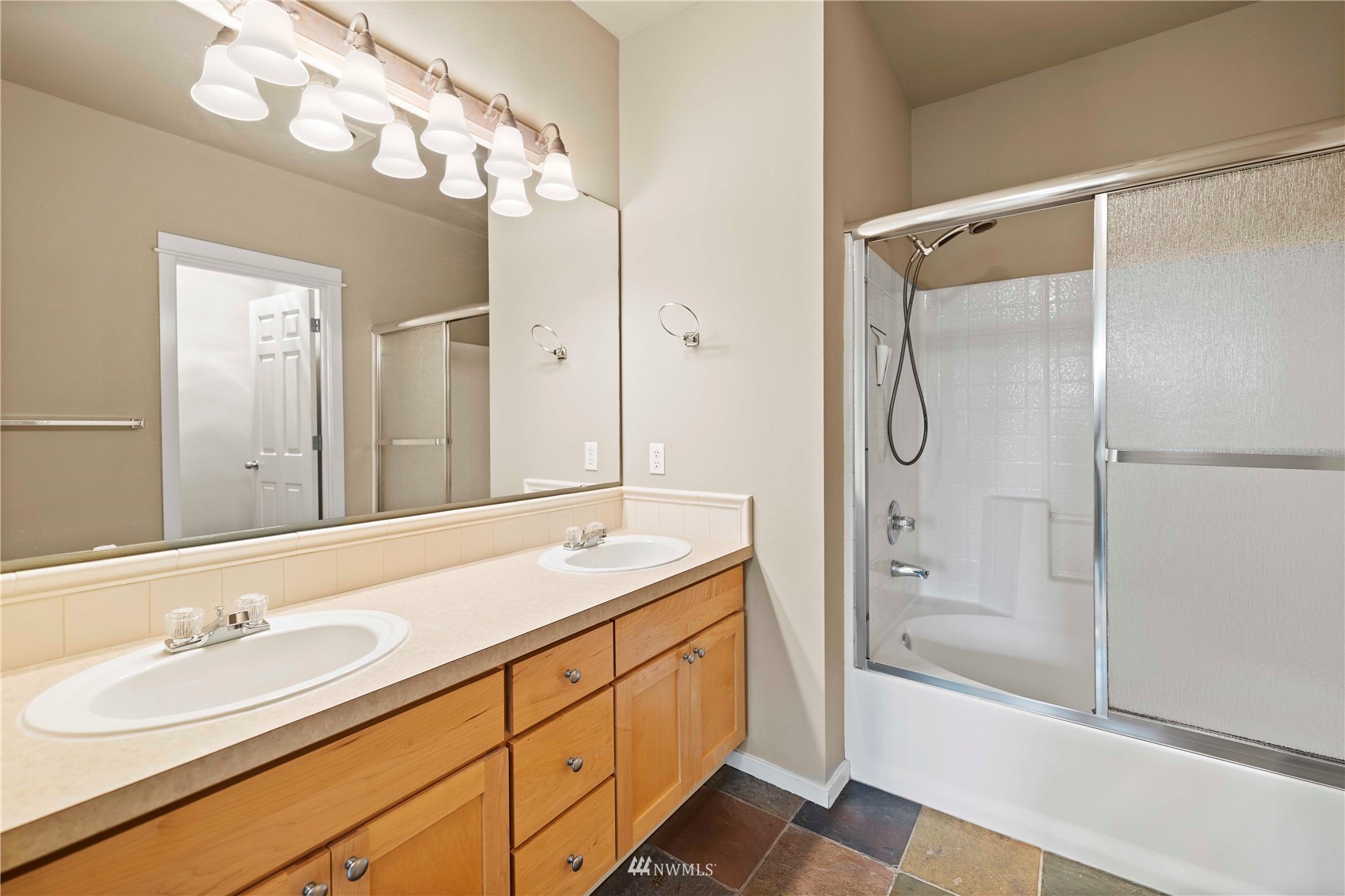 2009 196th Street Southeast, Unit D201 Bothell, WA 98012 - Photo 15 of 30 a bathroom with a granite countertop sink mirror and shower