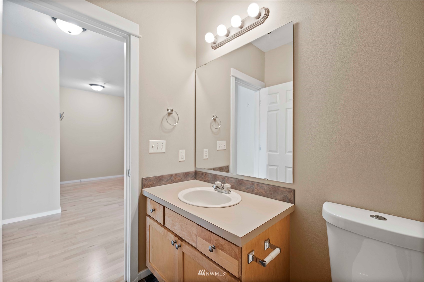 2009 196th Street Southeast, Unit D201 Bothell, WA 98012 - Photo 19 of 30 a bathroom with a sink a toilet and a mirror