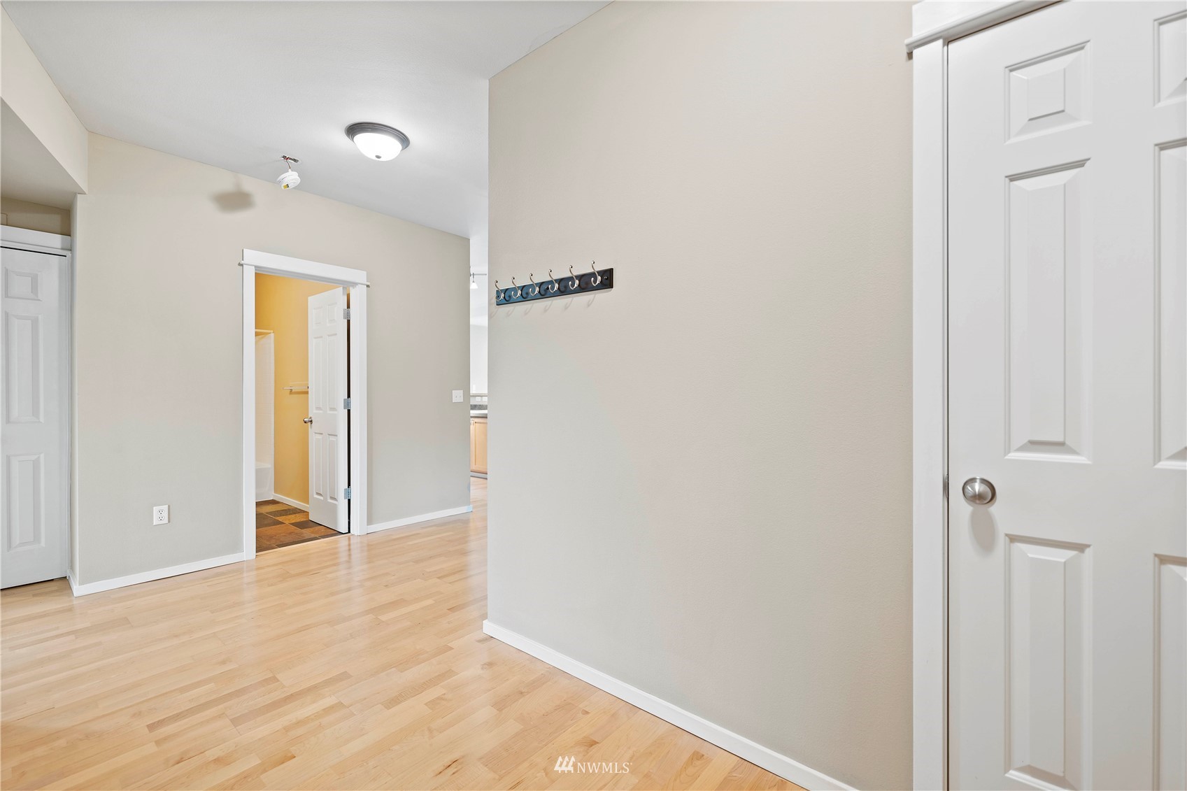2009 196th Street Southeast, Unit D201 Bothell, WA 98012 - Photo 2 of 30 a view of a hallway with wooden floor and closet area