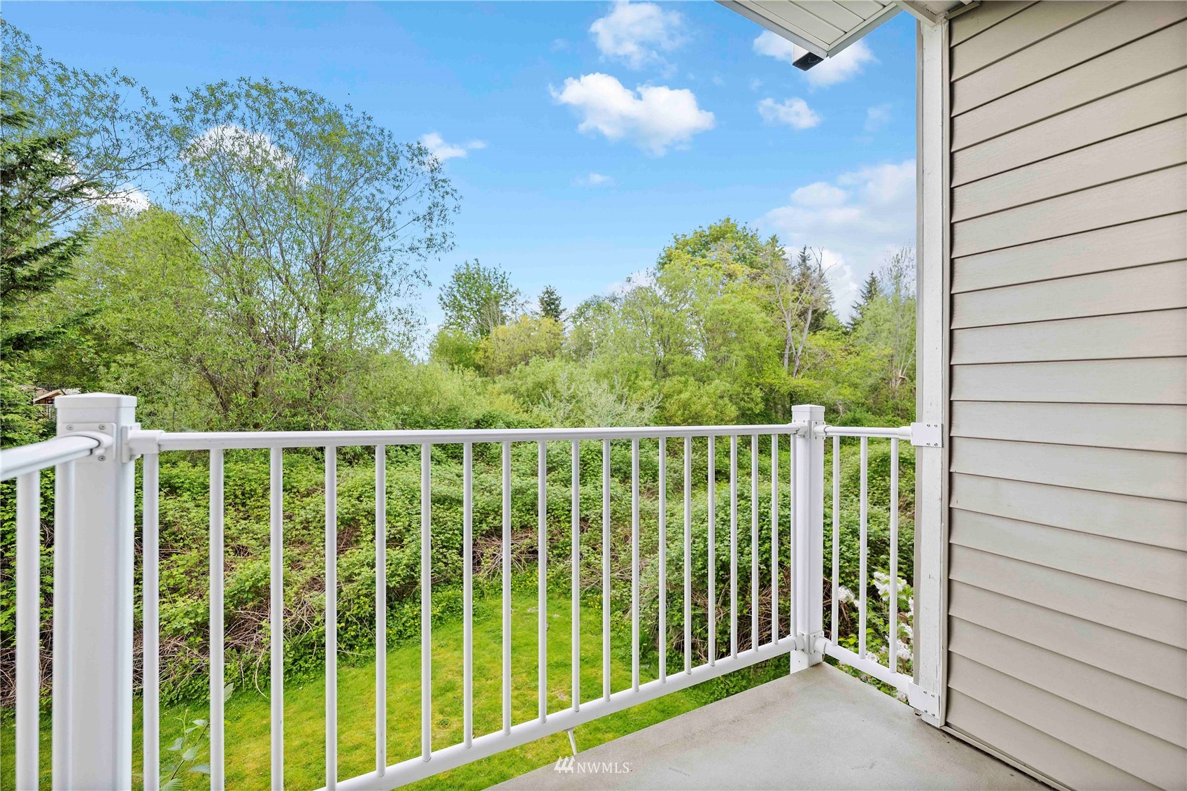 2009 196th Street Southeast, Unit D201 Bothell, WA 98012 - Photo 24 of 30 a balcony with trees in front of it