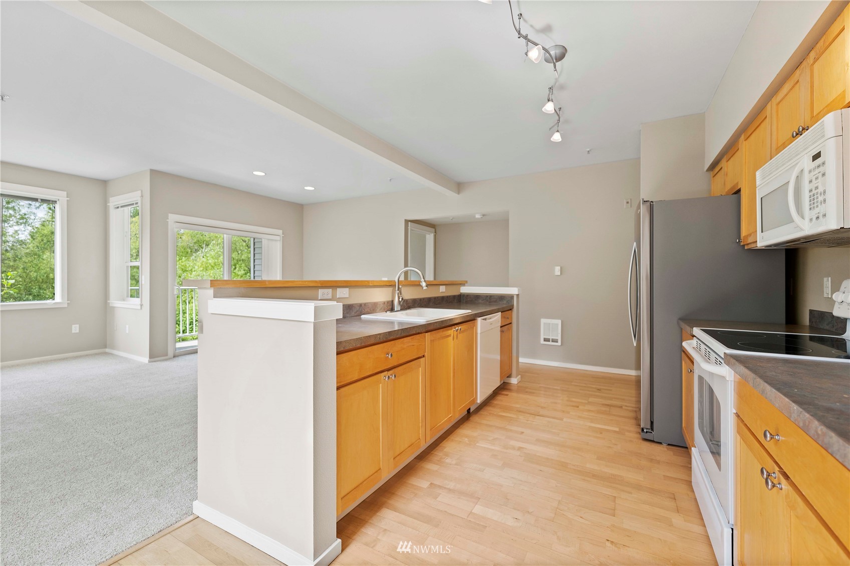 2009 196th Street Southeast, Unit D201 Bothell, WA 98012 - Photo 4 of 30 a kitchen with kitchen island a sink stove and refrigerator