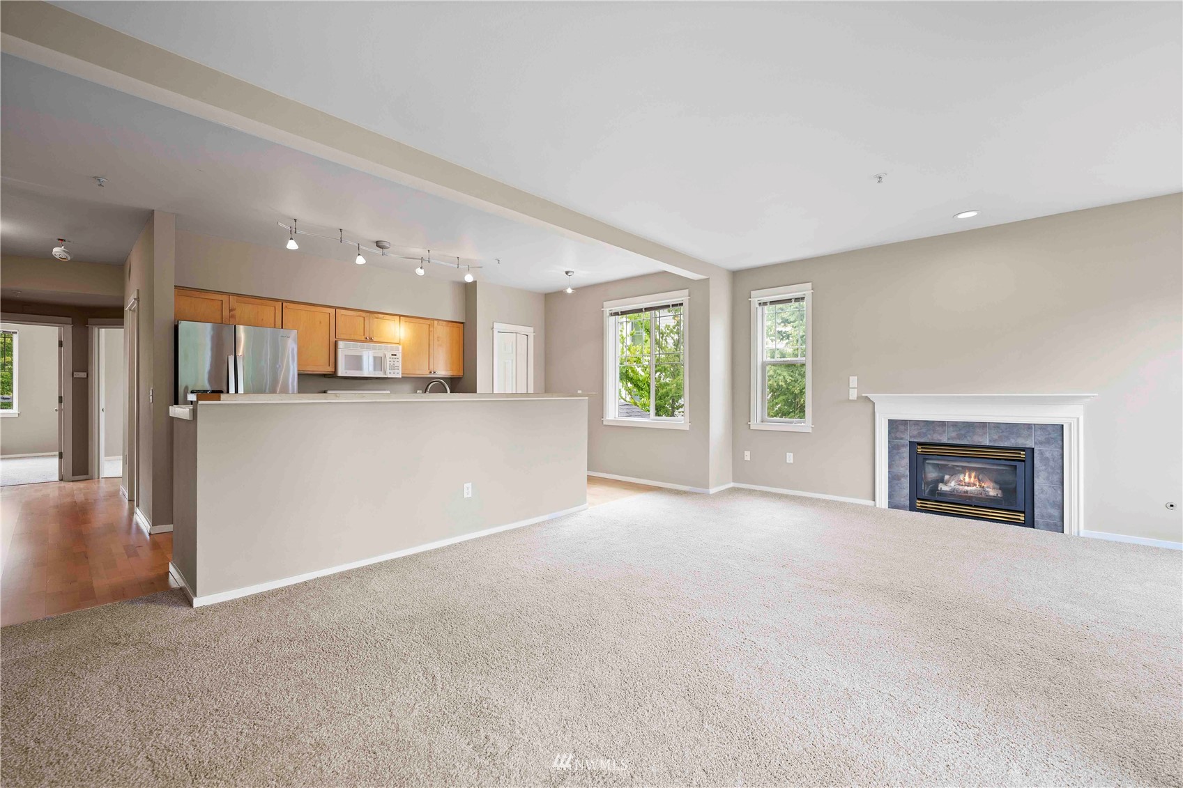 2009 196th Street Southeast, Unit D201 Bothell, WA 98012 - Photo 7 of 30 an empty room with a fireplace and window