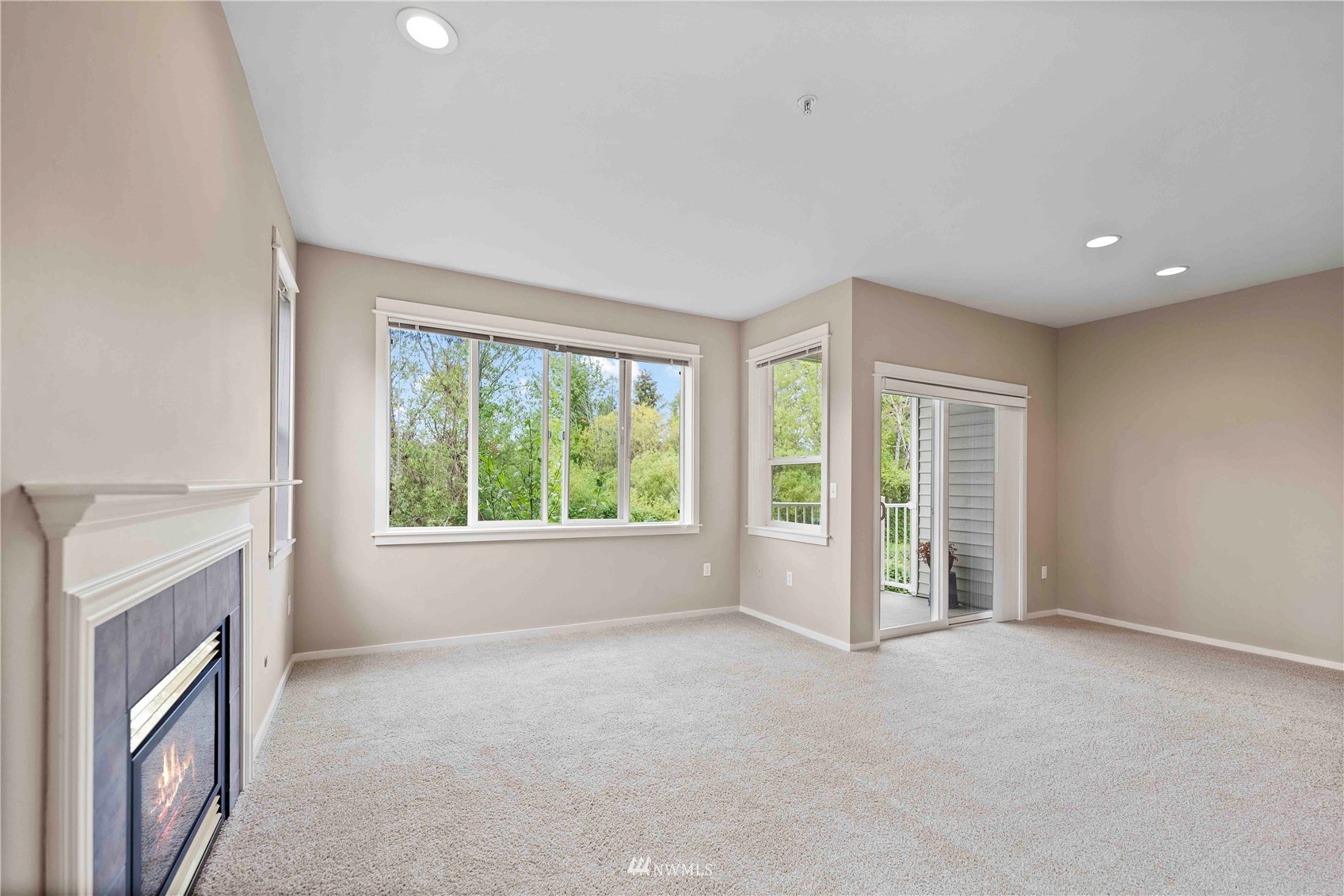2009 196th Street Southeast, Unit D201 Bothell, WA 98012 - Photo 8 of 30 a view of an empty room with a fireplace and a window