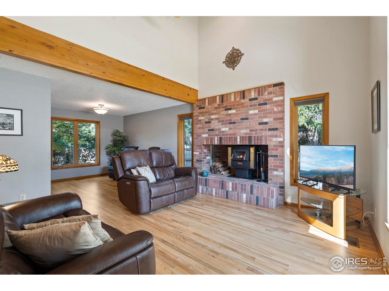 1213 Centennial Road Fort Collins, CO 80525 - Photo 5 of 29 Enjoy the cozy living room with a beautiful brick fireplace.