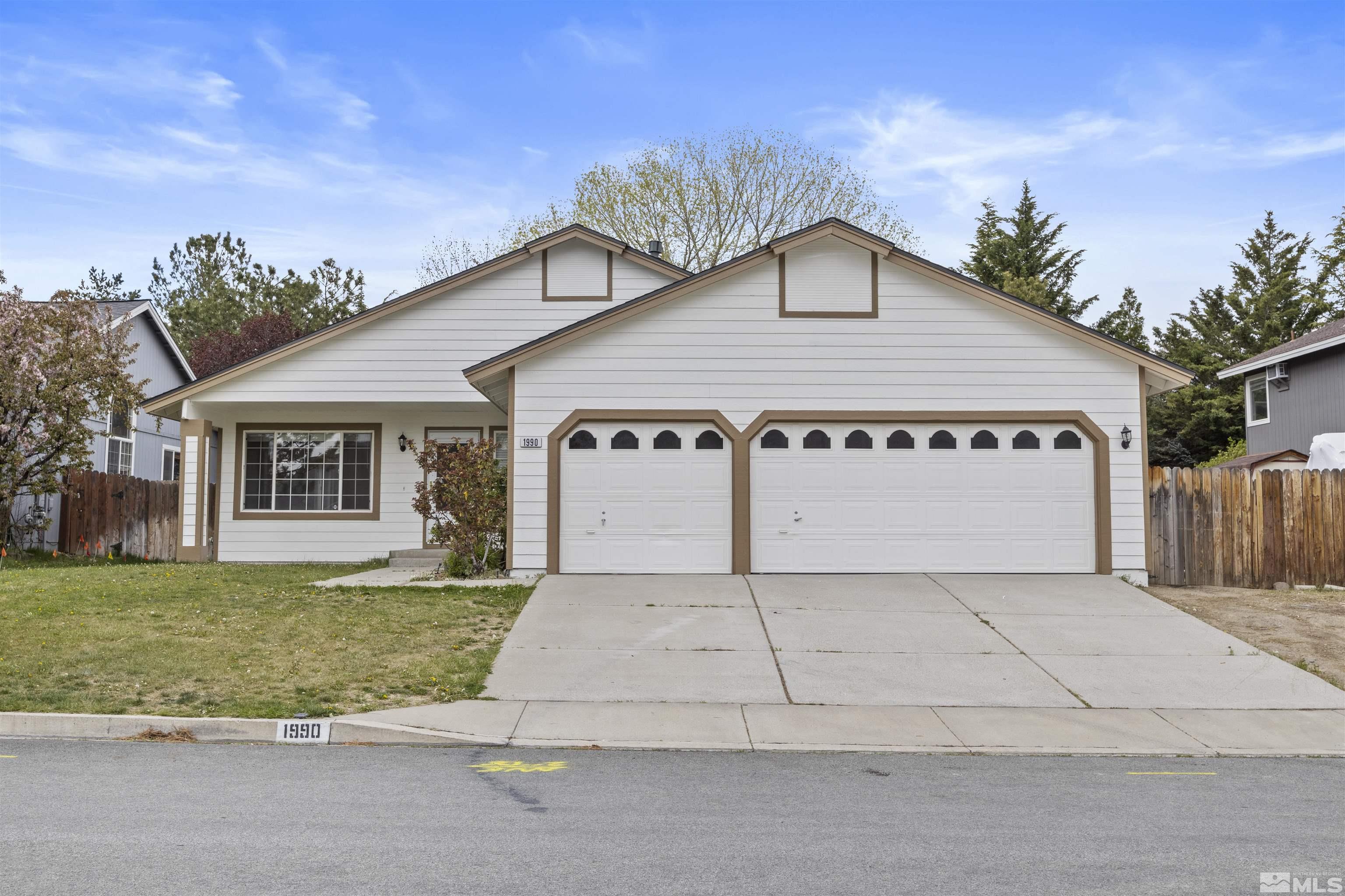 1990 Honey Ridge Drive Reno, NV 89511 - Photo 1 of 24 a view of a house with a yard and potted plants