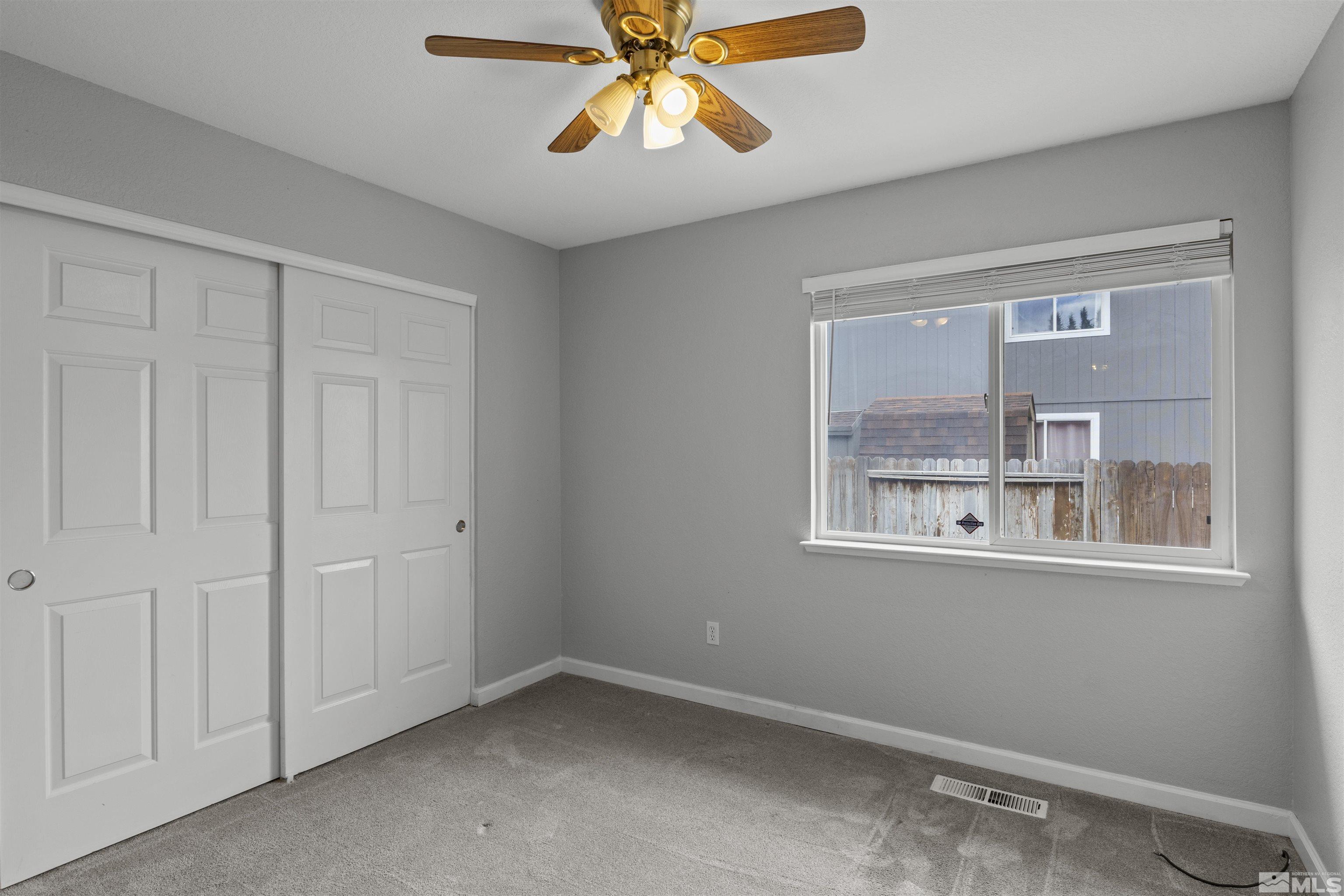 1990 Honey Ridge Drive Reno, NV 89511 - Photo 13 of 24 wooden floor in an empty room with a window