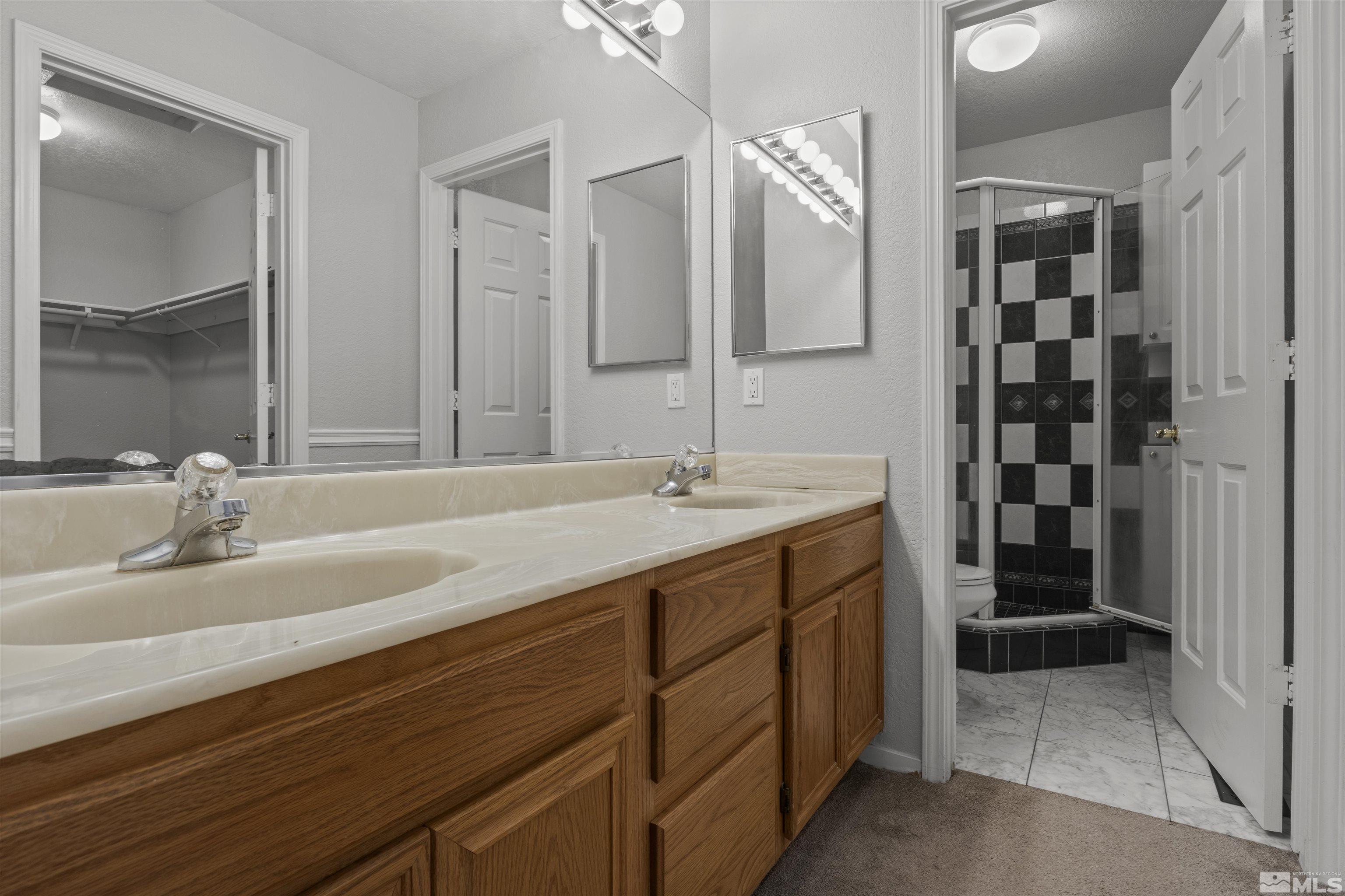 1990 Honey Ridge Drive Reno, NV 89511 - Photo 16 of 24 a bathroom with a double vanity sink and a mirror