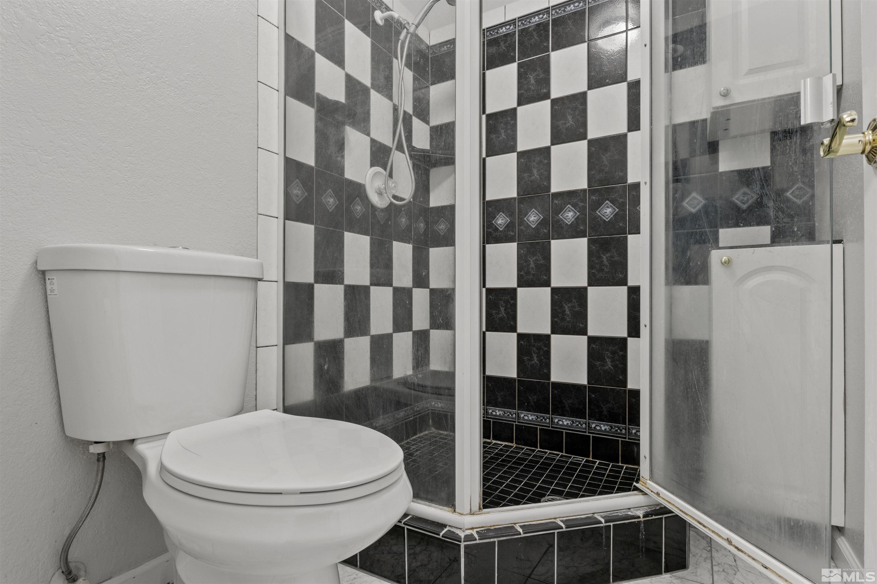 1990 Honey Ridge Drive Reno, NV 89511 - Photo 17 of 24 a bathroom with a toilet and a shower