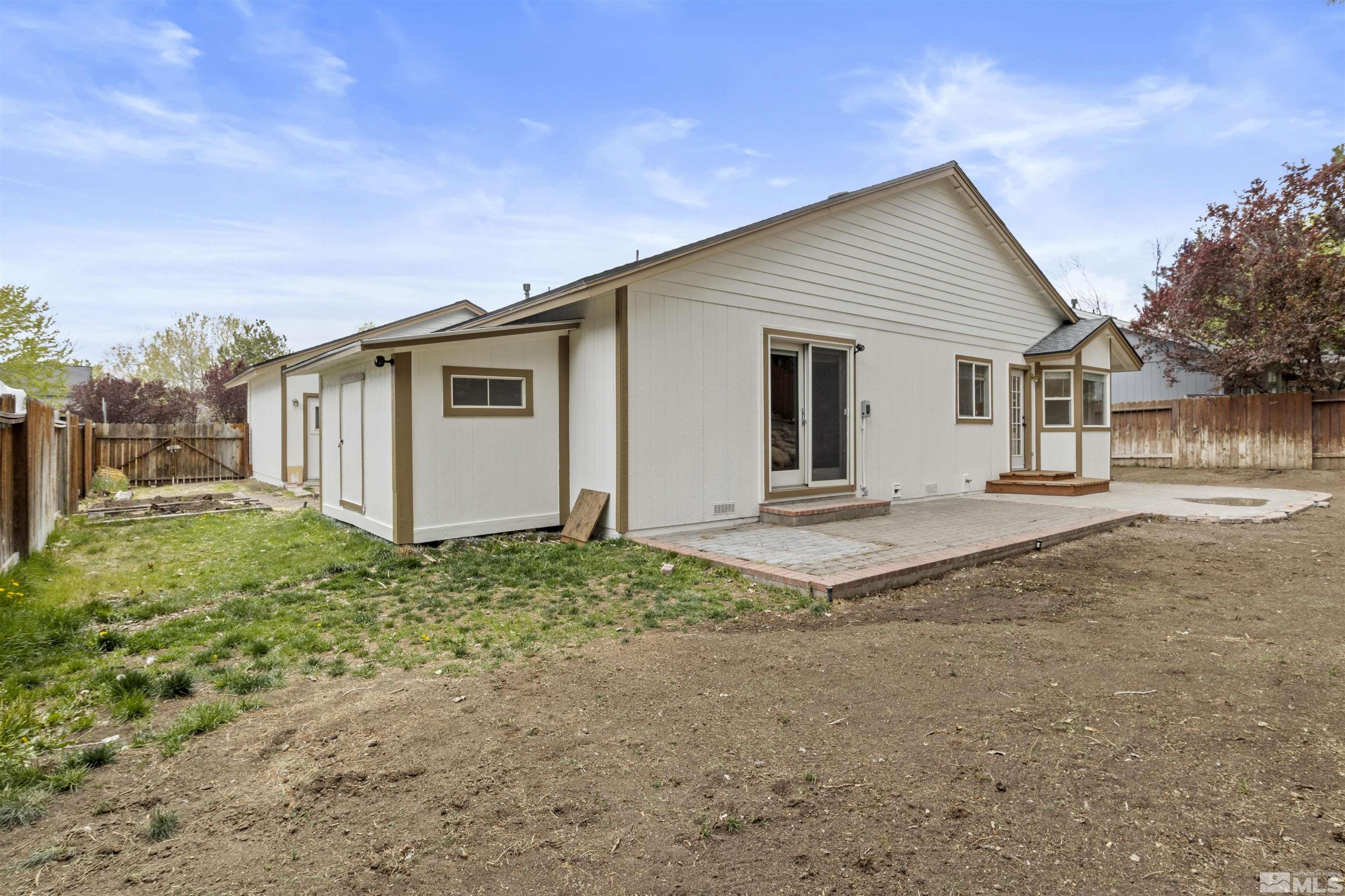 1990 Honey Ridge Drive Reno, NV 89511 - Photo 23 of 24 a view of a house with backyard and trees