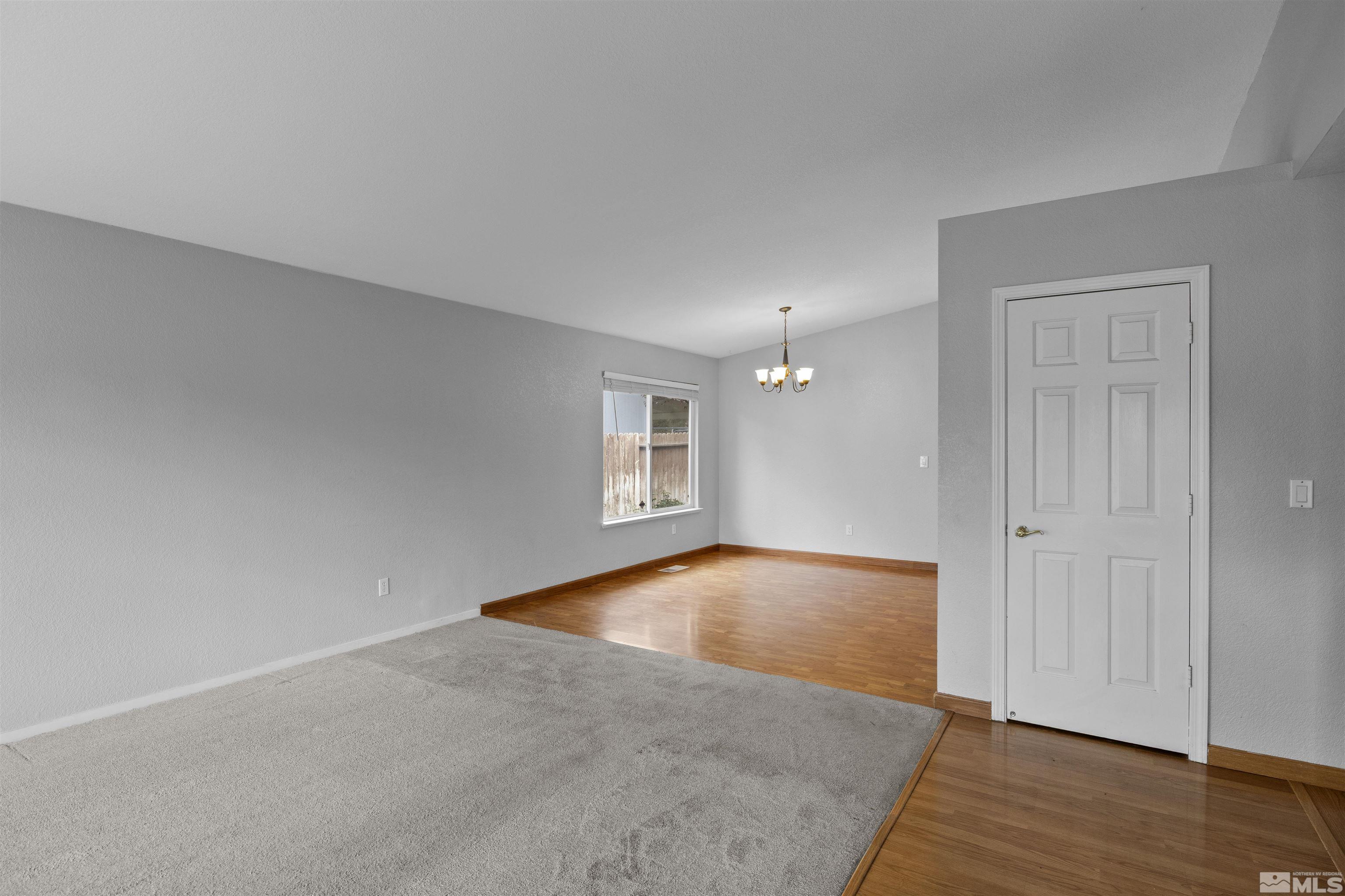 1990 Honey Ridge Drive Reno, NV 89511 - Photo 3 of 24 an empty room with wooden floor and windows