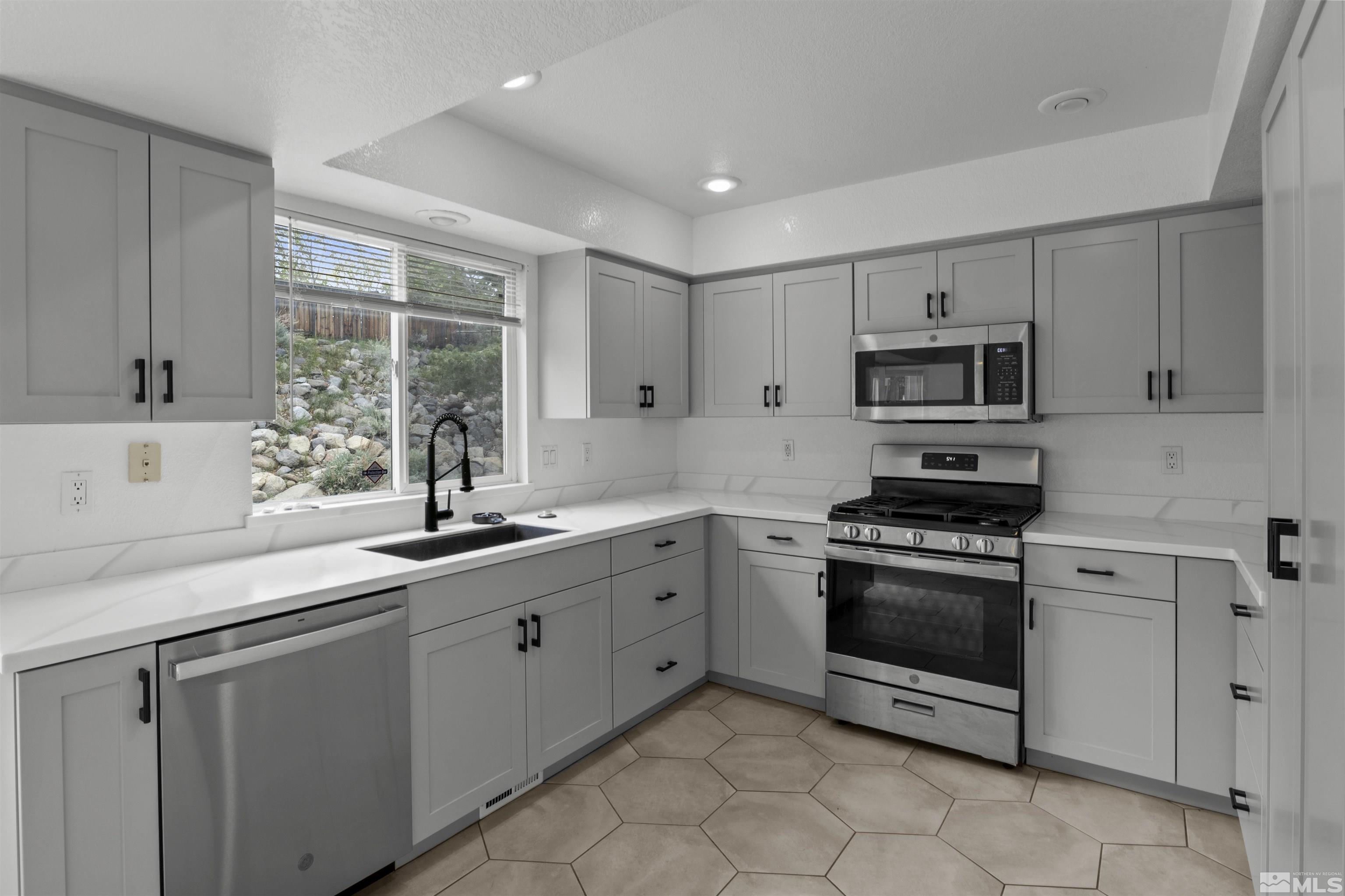 1990 Honey Ridge Drive Reno, NV 89511 - Photo 9 of 24 a kitchen with sink a microwave and cabinets