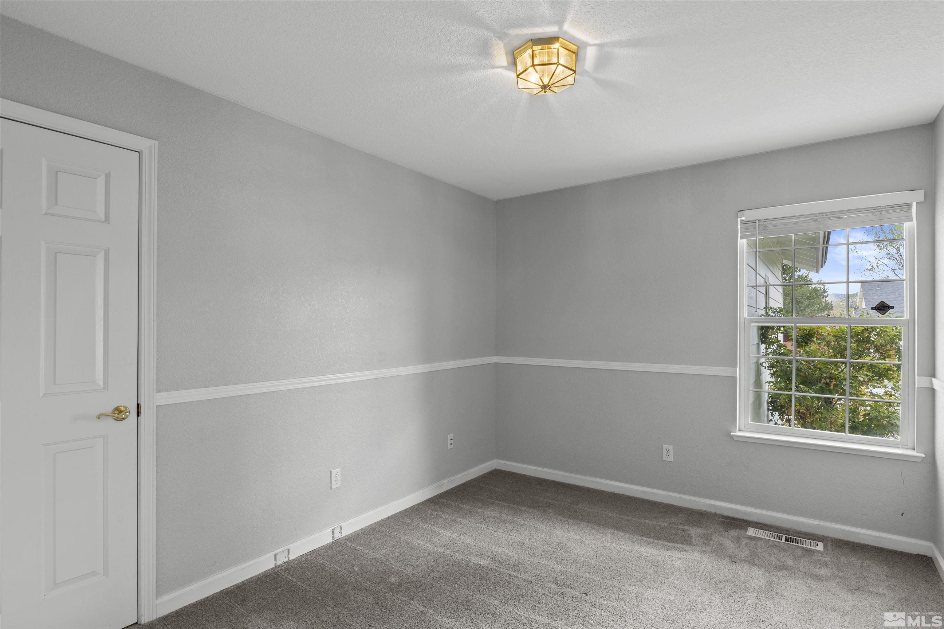 1990 Honey Ridge Drive Reno, NV 89511 - Photo 10 of 24 an empty room with a window