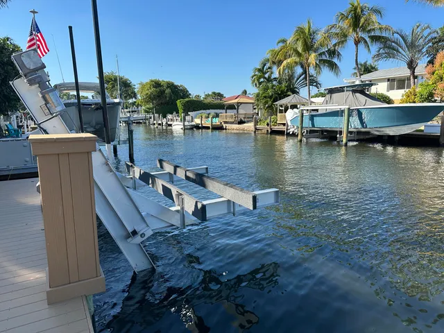 a backyard of a house with table and chairs under an umbrella