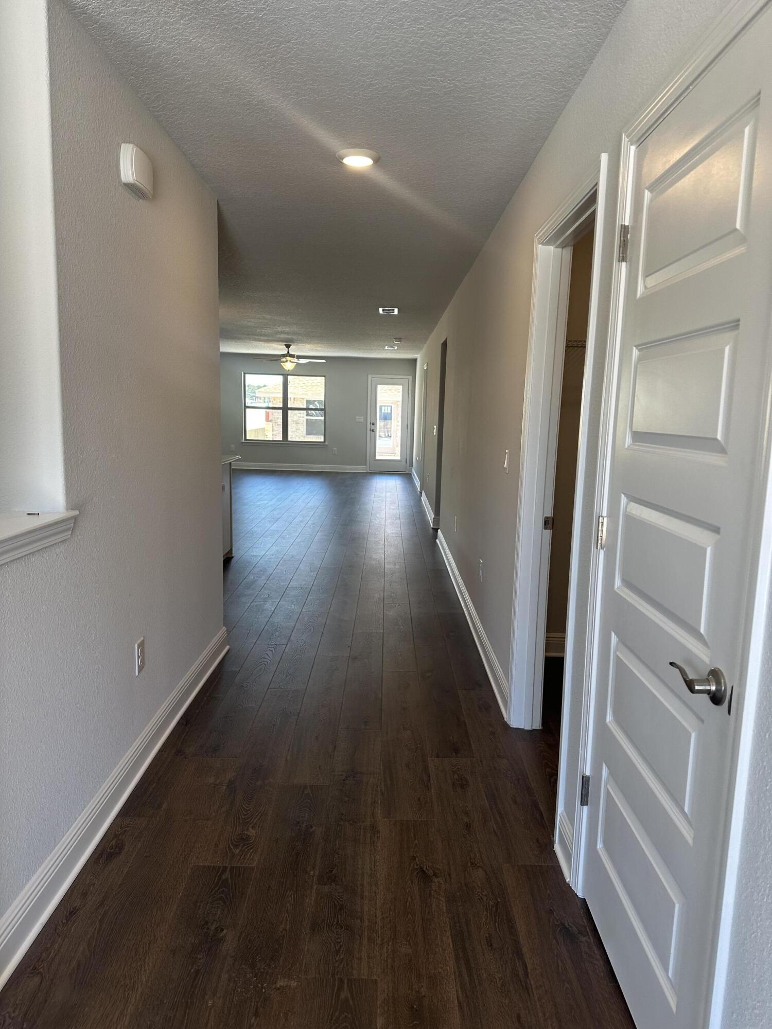 329 Keswick Lane Crestview, FL 32536 - Photo 5 of 22 wooden floor in an empty room with a mirror