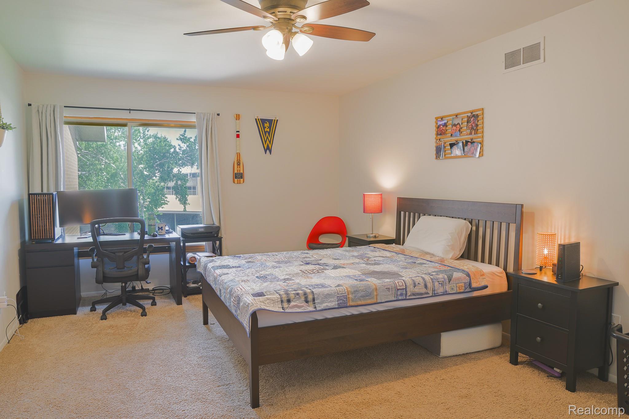 1989 Klingensmith Road, Unit 46 Bloomfield Hills, MI 48302 - Photo 26 of 41 Spacious bedroom featuring light-toned carpeting and neutral wall tones
