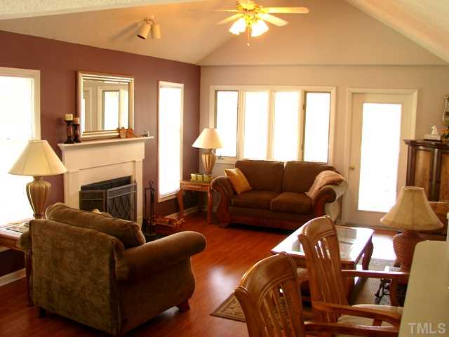 533 Springfork Drive Cary, NC 27513 - Photo 3 of 14 15x13. Wood-burning fireplace. Vaulted ceiling. Wood floors.