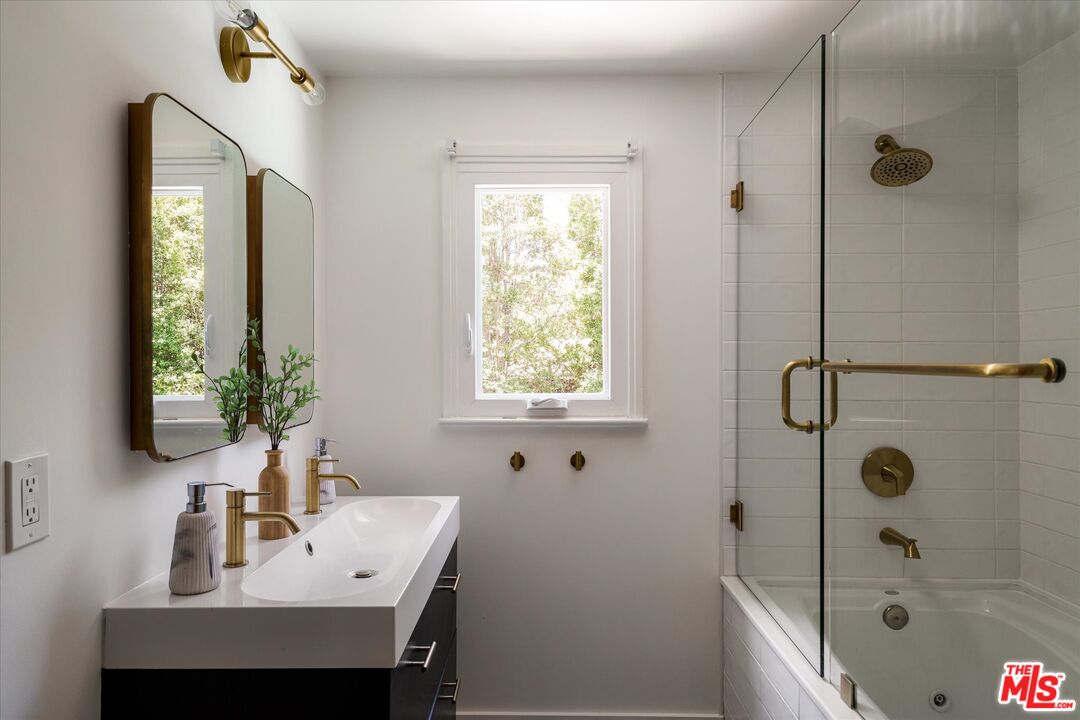 1767 Hillside Drive Glendale, CA 91208 - Photo 21 of 51 a bathroom with a sink a mirror and a shower