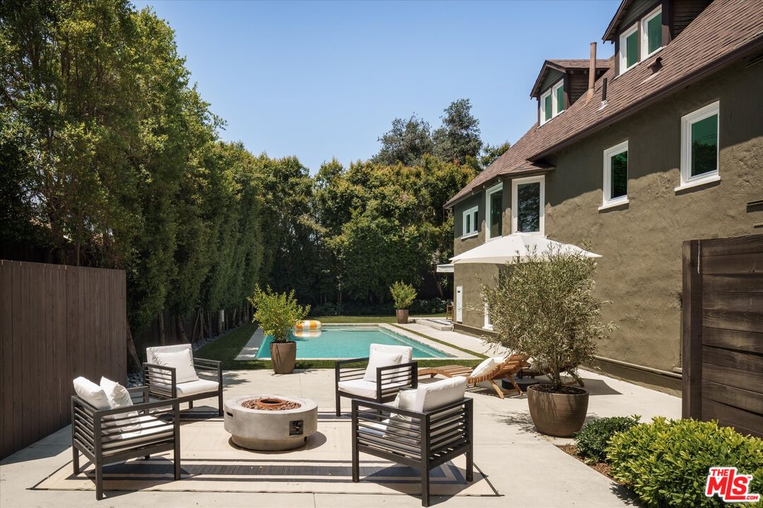 1767 Hillside Drive Glendale, CA 91208 - Photo 36 of 51 a view of a patio with table and chairs potted plants and a large tree