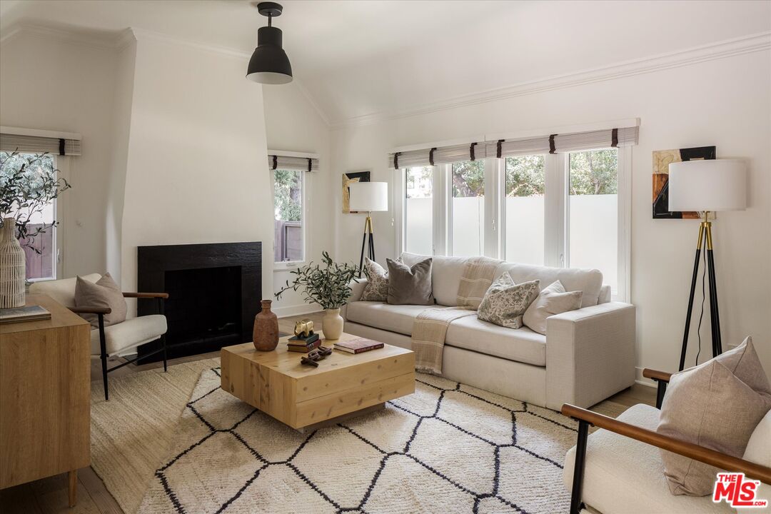 1767 Hillside Drive Glendale, CA 91208 - Photo 8 of 51 a living room with furniture a fireplace and a table