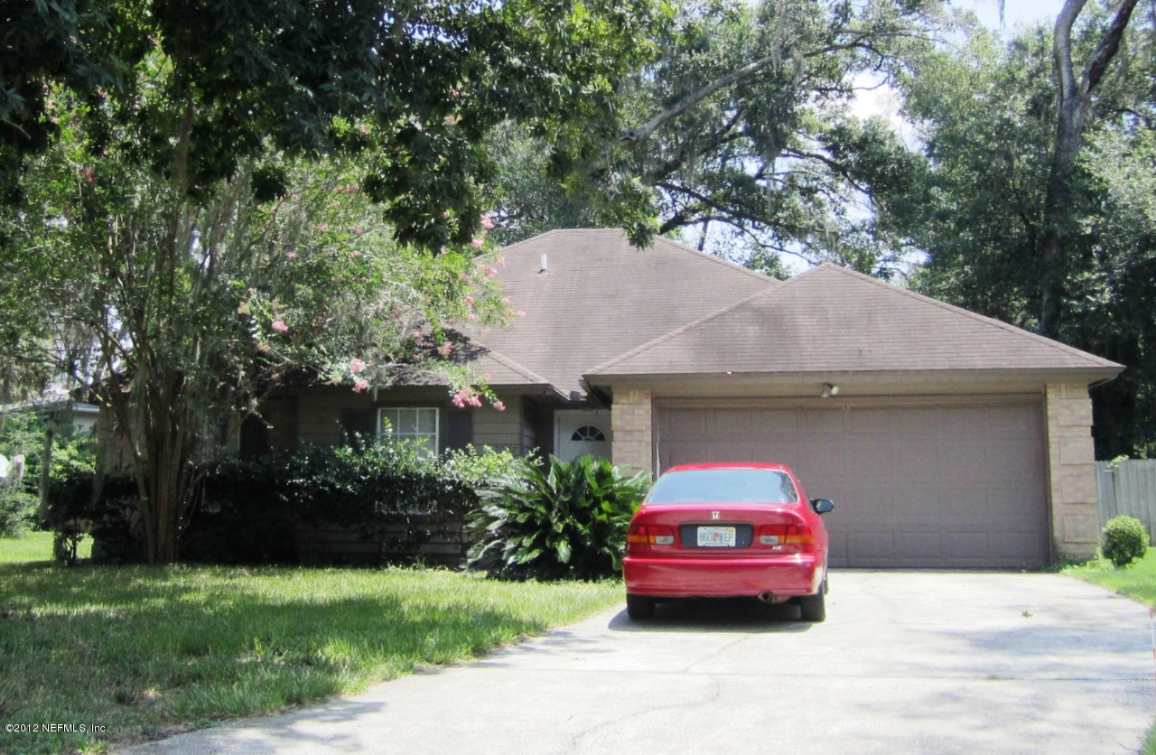 2047 Matefield Road Jacksonville, FL 32225 - Photo 1 of 4 a front view of a house with a garden