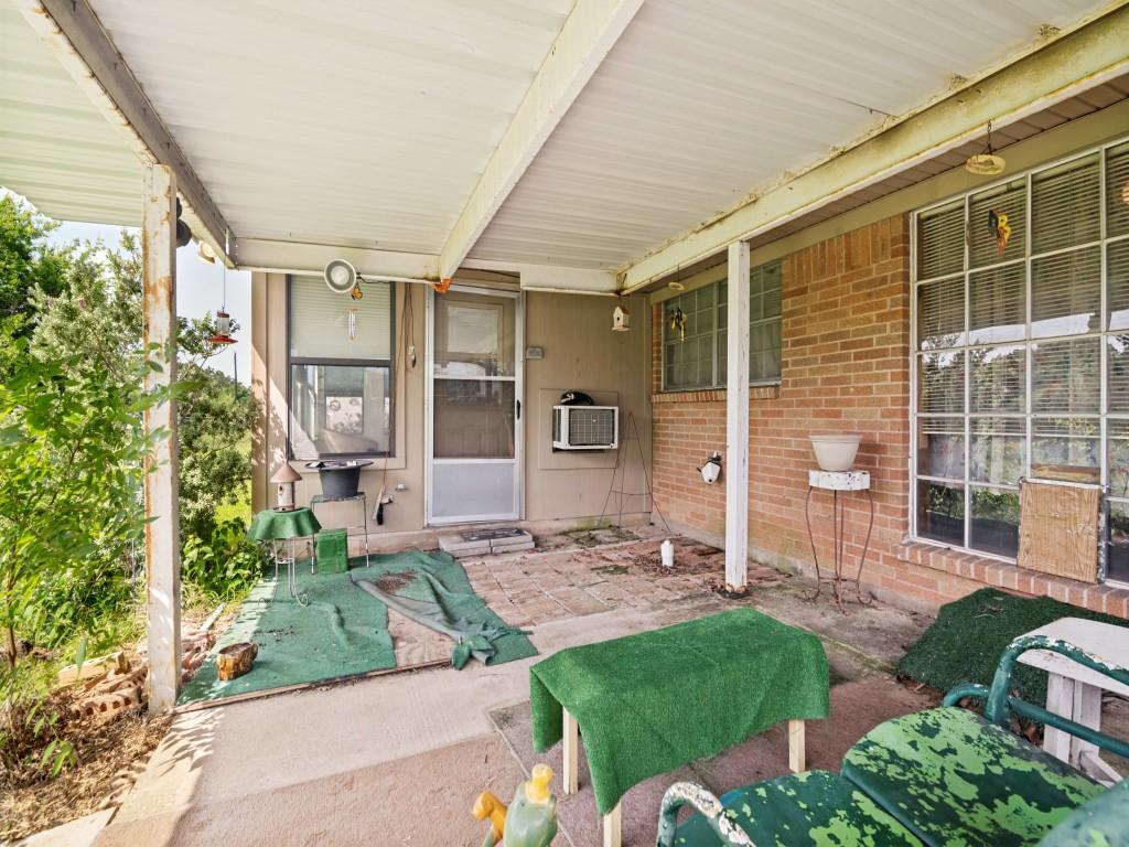 1081 Wright Street Terrell, TX 75160 - Photo 26 of 29 Covered back patio space featuring a corrugated metal roof and concrete flooring