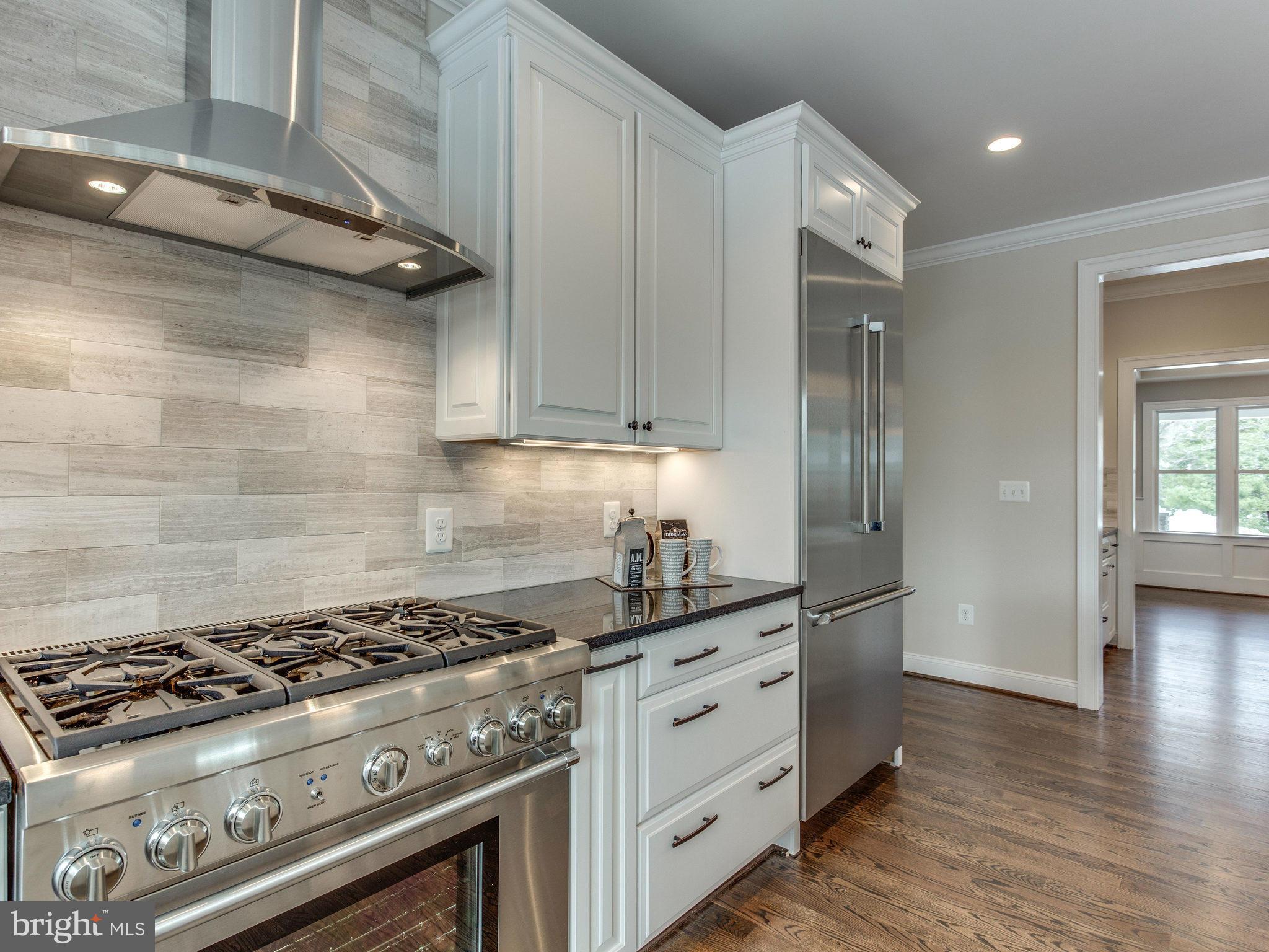3100 North Rochester Street Arlington, VA 22213 - Photo 14 of 30 a kitchen with granite countertop a stove and a refrigerator