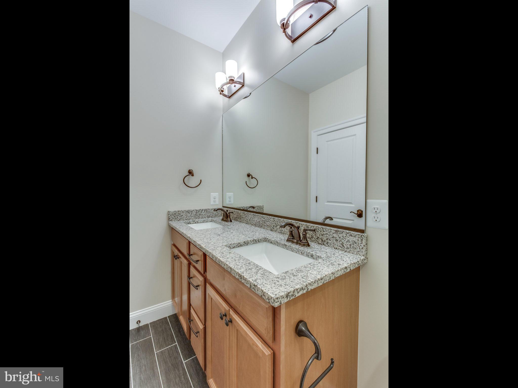 3100 North Rochester Street Arlington, VA 22213 - Photo 25 of 30 a bathroom with a granite countertop sink and a mirror