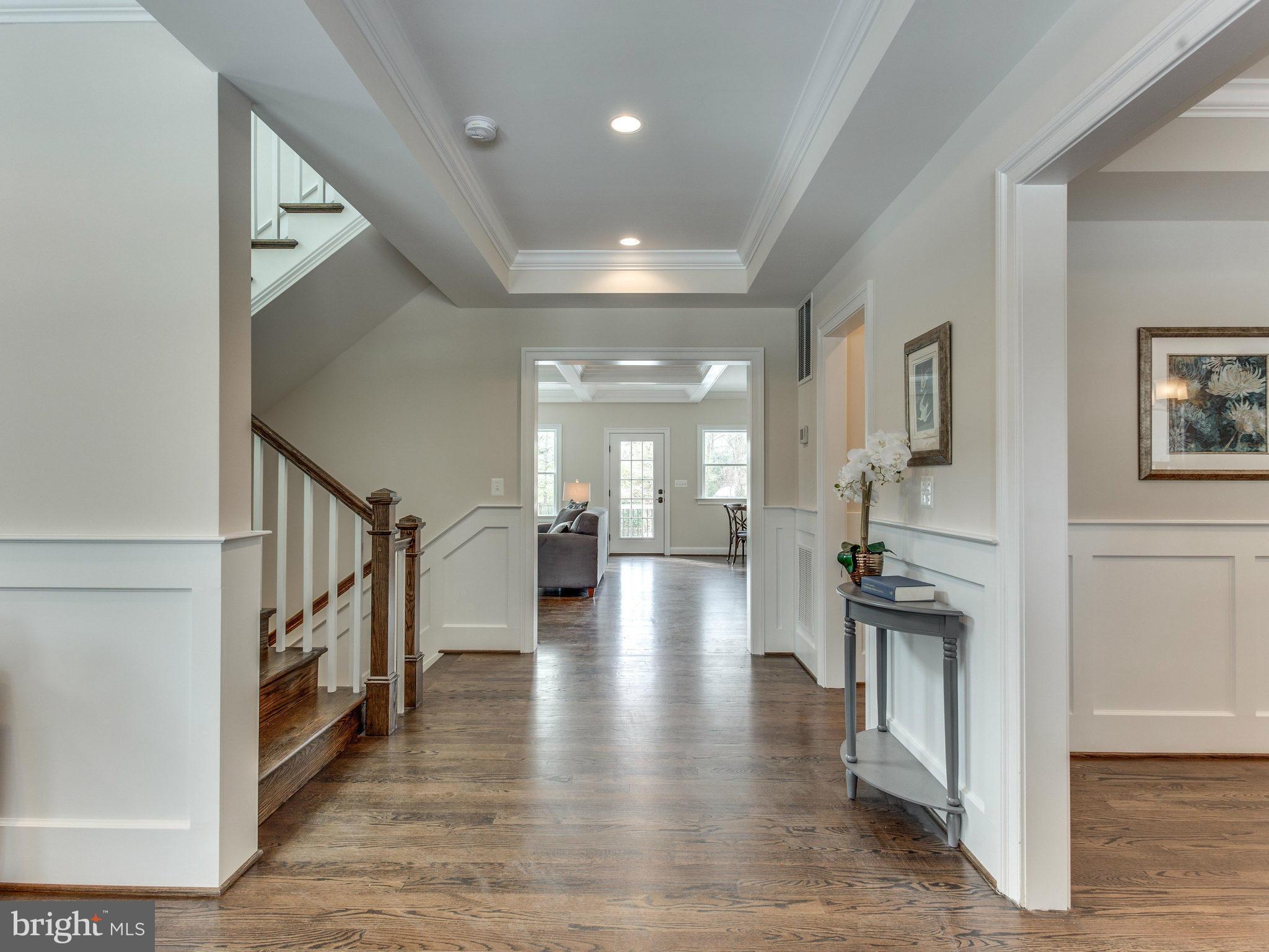 3100 North Rochester Street Arlington, VA 22213 - Photo 5 of 30 a hallway with wooden floor windows and a kitchen view