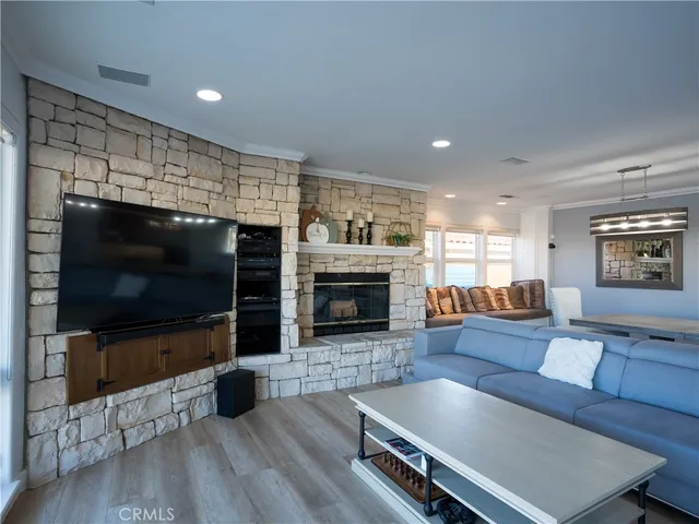 a living room with furniture flat screen tv and a fireplace