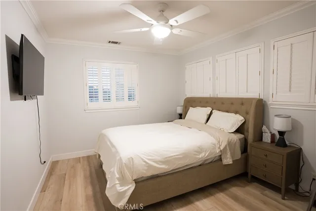 a bedroom with a bed and a television