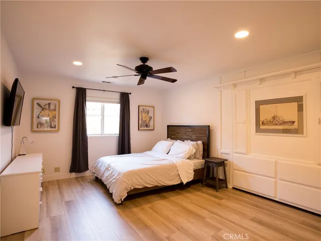 a bedroom with a bed and a large mirror