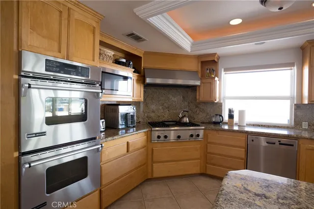 a kitchen with stainless steel appliances granite countertop a stove and a sink