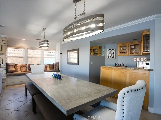 a dining room with a table chairs and flat screen tv