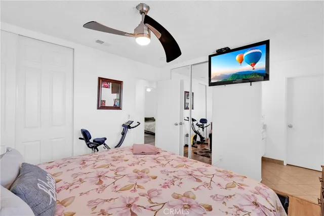 a bedroom with a bed and a painting on the wall