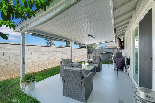 a view of a patio with table and chairs and potted plants