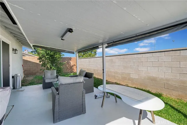 a view of a porch with furniture and a yard