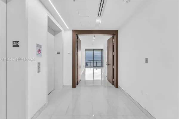 a view of a hallway with wooden shelves