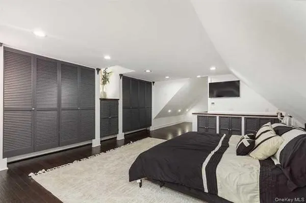 a bedroom with a bed and a refrigerator