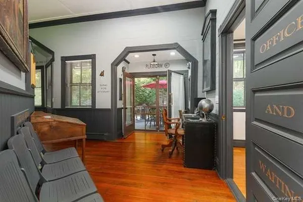 a living room with furniture a fireplace and large windows