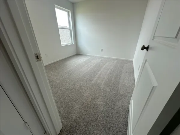 a view of room with window and refrigerator