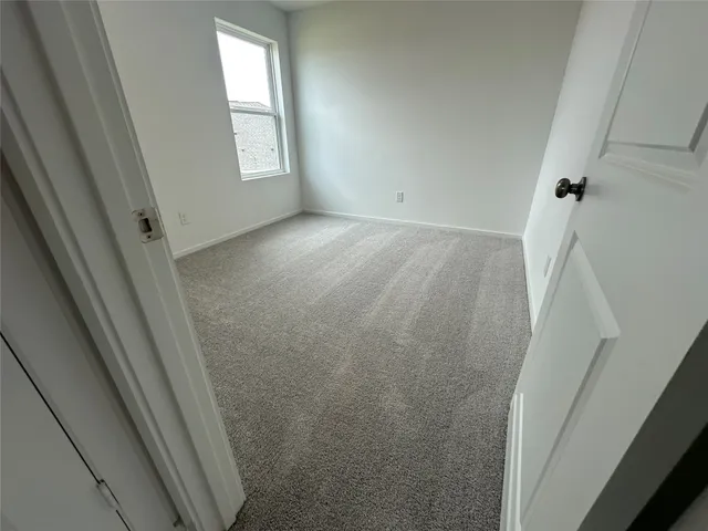 a view of room with window and refrigerator