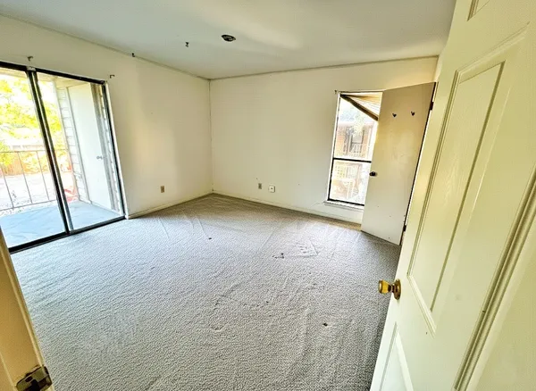 a view of a room with window and wooden floor