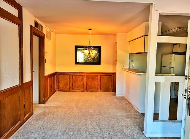 a view of a hallway with paintings on the wall