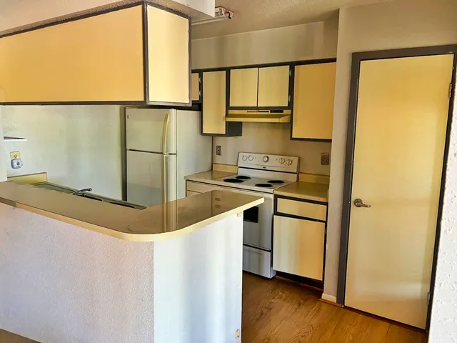a kitchen with stainless steel appliances a refrigerator sink and cabinets