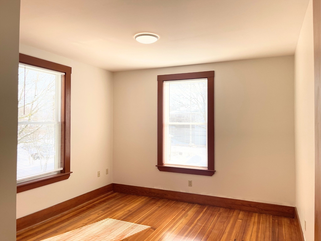 25 Bennett Street, Unit 2 Beverly, MA 01915 - Photo 12 of 17 an empty room with windows