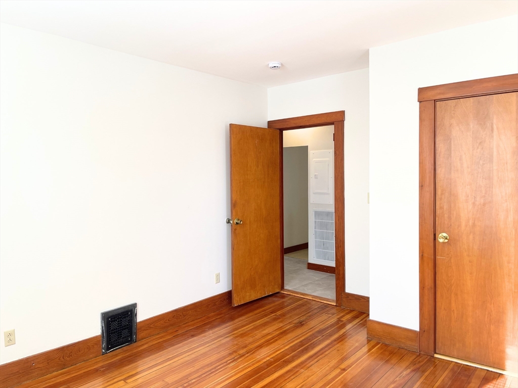 25 Bennett Street, Unit 2 Beverly, MA 01915 - Photo 13 of 17 a view of an empty room with wooden floor
