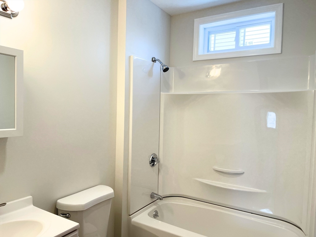 25 Bennett Street, Unit 2 Beverly, MA 01915 - Photo 14 of 17 a bathroom with a toilet and a tub